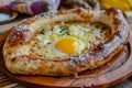 Homemade Ajarian Khachapuri with Sulguni Cheese Filled with a Raw Egg and Melted Butter Close Up