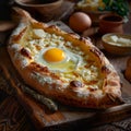 Homemade Ajarian Khachapuri with Sulguni Cheese Filled with a Raw Egg and Melted Butter Close Up