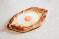 Homemade Ajarian Khachapuri with Suluguni Cheese Filled with a Egg and Melted Butter Close Up