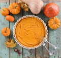 Homemade American pumpkin pie in white ceramic dish surrounded w Royalty Free Stock Photo