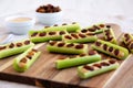 Homemade ants on a log with celery, peanut butter and raisins on a wooden board, side view. Close-up Royalty Free Stock Photo