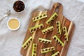 Homemade ants on a log with celery, peanut butter and raisins on a wooden board, top view Royalty Free Stock Photo