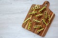 Homemade ants on a log with celery, peanut butter and raisins on a wooden board, top view Royalty Free Stock Photo