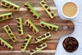 Homemade ants on a log with celery, peanut butter and raisins on a wooden board, top view Royalty Free Stock Photo