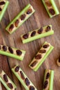 Homemade ants on a log with celery, peanut butter and raisins on a wooden board, top view. Close-up Royalty Free Stock Photo