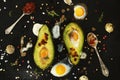 Homemade appetizer - baked avocado with quail eggs, black salt Royalty Free Stock Photo