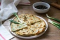 Homemade appetizing scallion pancakes and a bunch of green onions. Rustic style. Royalty Free Stock Photo