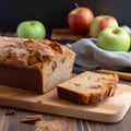 Homemade apple cake with raisins and cinnamon on wooden table.