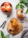 Homemade apple cider with apples and cinnamon in glasses on a light background with fresh fruits, spices and branch. The concept Royalty Free Stock Photo