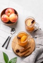 Homemade apple cider with apples and cinnamon in glasses on a light background with fresh fruits, spices and branch. The concept Royalty Free Stock Photo