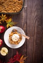 Homemade apple cramble crisp cake on white plate with autumn leaves on the background Royalty Free Stock Photo