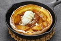 Homemade apple dutch baby pancake with ice cream