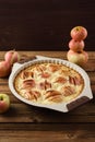 Homemade apple pie in baking dish served with raw organic apples Royalty Free Stock Photo