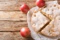 Homemade apple pie charlotte and piece of cake close-up on a parchment paper. Horizontal top view from above Royalty Free Stock Photo