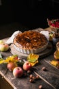 Homemade apple pie surrounded by fresh fruits, nuts, apples