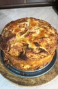 Homemade apple, raisin and cranberry pie, on round wooden board