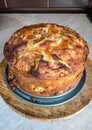 Homemade apple, raisin and cranberry pie, on round wooden board