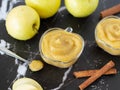 Homemade applesauce apple puree or mousse in small glass bowls with organic golden delicious apples and cinnamon sticks Royalty Free Stock Photo