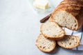 Homemade artisanal sliced sourdough bread on a napkin and butter with knife. Healthy home baking concept Royalty Free Stock Photo