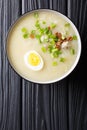 Homemade Asian rice soup with chicken, vegetables and egg close-up. vertical top view Royalty Free Stock Photo