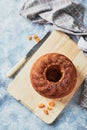 Homemade autumn carrot cake with candied fruits on wooden cutting board