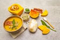 Homemade autumn hot pumpkin cream soup with smocked bacon and seeds. Raw pumpkin, bun, fresh chives, dill, salt in spoon, vintage Royalty Free Stock Photo