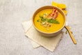 Homemade autumn hot pumpkin cream soup with smocked bacon and seeds. Raw pumpkin, fresh chives, dill, salt in spoon, vintage linen Royalty Free Stock Photo