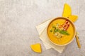 Homemade autumn hot pumpkin cream soup with smocked bacon and seeds. Raw pumpkin, fresh chives, dill, salt in spoon, vintage linen Royalty Free Stock Photo