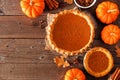 Homemade autumn pumpkin pie, top view corner border over a rustic wood background Royalty Free Stock Photo