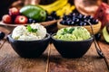 Homemade avocado and banana ice cream in handmade clay pot, with tropical fruits in the background Royalty Free Stock Photo