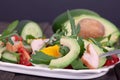 Homemade avocado salad with rucola, chicken chops and mixed vegetables