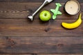 Homemade baby food. Cook puree with apple and banana with immersion blender. Dark wooden background with toy top view Royalty Free Stock Photo