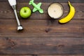 Homemade baby food. Cook puree with apple and banana with immersion blender. Dark wooden background with toy top view Royalty Free Stock Photo