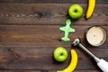 Homemade baby food. Cook puree with apple and banana with immersion blender. Dark wooden background with toy top view Royalty Free Stock Photo