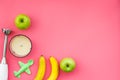 Homemade baby food. Cook puree with apple and banana with immersion blender. Pink background with toy top view space for Royalty Free Stock Photo