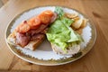 Homemade bacon and fried tomato and lettuce baguette open sandwich, Sometimes called a BLT before closing on a white plate