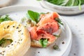 Homemade bagel sandwich with smoked salmon, cream cheese, capers and spinach close up for healthy breakfast Royalty Free Stock Photo