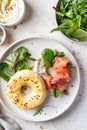 Homemade bagel sandwich with smoked salmon, cream cheese, capers and spinach close up for healthy breakfast top view Royalty Free Stock Photo