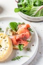 Homemade bagel sandwich with smoked salmon, cream cheese, capers and spinach close up for healthy breakfast Royalty Free Stock Photo