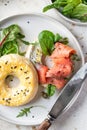 Homemade bagel sandwich with smoked salmon, cream cheese, capers and spinach for healthy breakfast close up top view Royalty Free Stock Photo