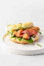 Homemade bagel sandwich with smoked salmon, cream cheese, capers and spinach for healthy breakfast isolated on white Royalty Free Stock Photo