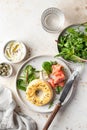 Homemade bagel sandwich with smoked salmon, cream cheese, capers and spinach for healthy breakfast top view Royalty Free Stock Photo