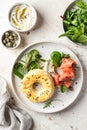 Homemade bagel sandwich with smoked salmon, cream cheese, capers and spinach for healthy breakfast top view Royalty Free Stock Photo