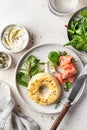 Homemade bagel sandwich with smoked salmon, cream cheese, capers and spinach for healthy breakfast top view Royalty Free Stock Photo