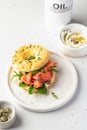 Homemade bagel sandwich with smoked salmon, cream cheese, capers and spinach for healthy breakfast on white kitchen Royalty Free Stock Photo