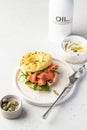 Homemade bagel sandwich with smoked salmon, cream cheese, capers and spinach for healthy breakfast on white kitchen Royalty Free Stock Photo