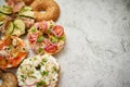 Homemade Bagel sandwiches with different toppings, salmon, cottage cheese, hummus, ham, radish
