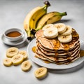 Homemade bake banana pancakes with topping fresh banana slices, walnuts and honey on whit plate