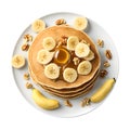 Homemade bake banana pancakes with topping fresh banana slices, walnuts and honey on whit plate