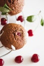 Homemade baked cherry muffins with fresh berries on white wooden table. Top view Royalty Free Stock Photo